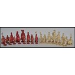 A fantastic early 19th Century Canton period ivory chess set the red stained side king and queen