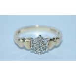 A hallmarked 9ct gold and diamond cluster ring. Hallmarked London. Size M. Weight 2g.