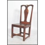 An 18th century north country oak dining chair having a panel seat with square legs united by