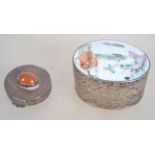 A 20th century Chinese white silvered metal pill pot having a painted scene together with another.