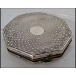 A silver hallmarked ladies compact by Vogue with e