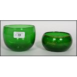 Two Georgian Bristol green glass finger bowls one being a plain green example and the other being