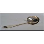 A large Danish silver  serving spoon - pouring ladel  with fabulous pierced rococo handle top. The