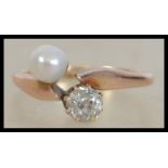 An early 20th century 9ct gold diamond and natural pearl ring. Diamond approx 30pts. Pearl