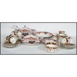 An Imari pattern 19th century part dinner service to include tureens and dinner plates etc