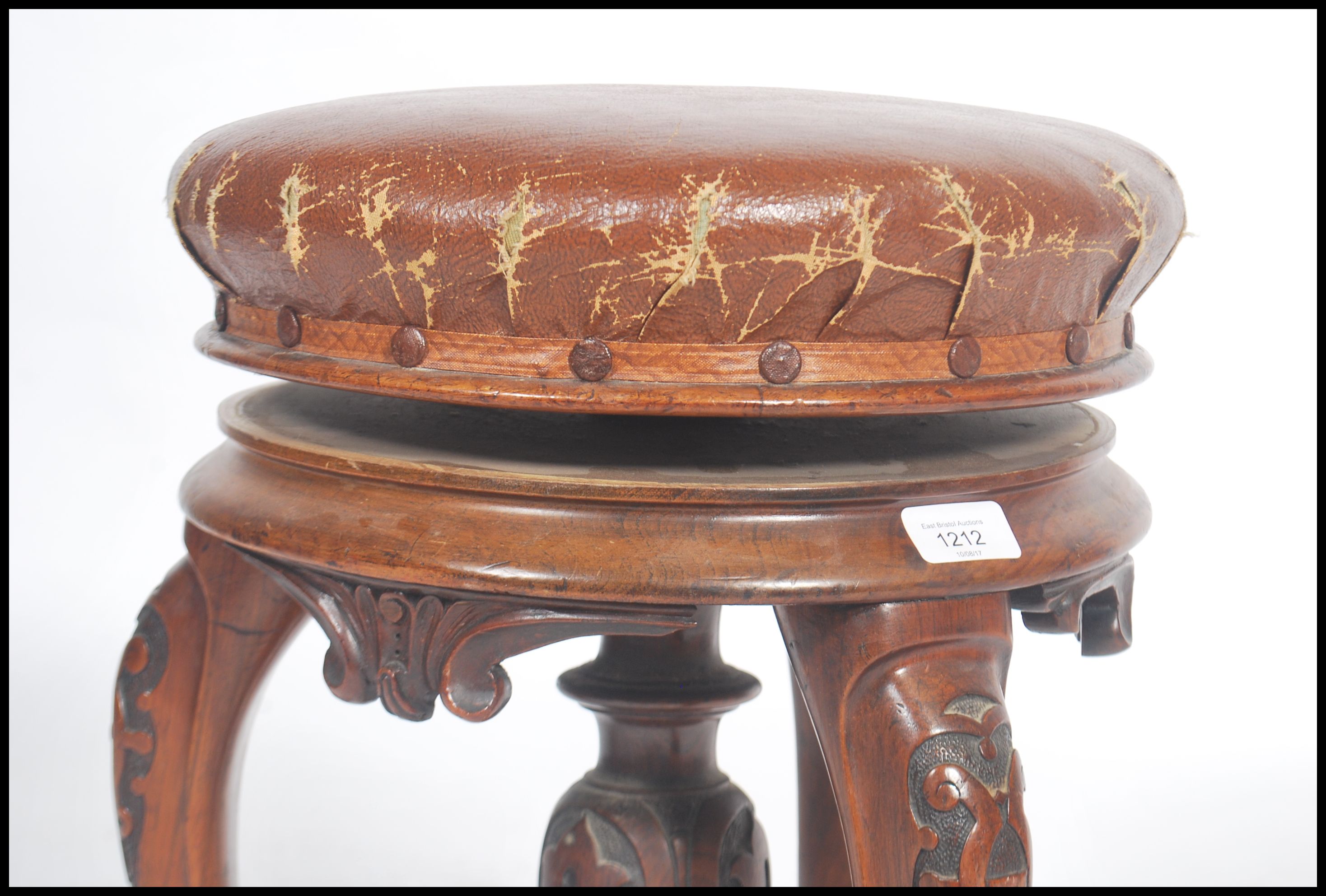 A Victorian tripod piano stool in walnut having lavishly carved cabriole legs and a faux leather - Image 4 of 5
