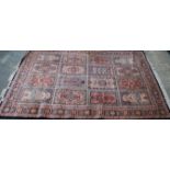 A large 20th century Persian / Islamic floor carpet rug having geometric medallions and spandrels.