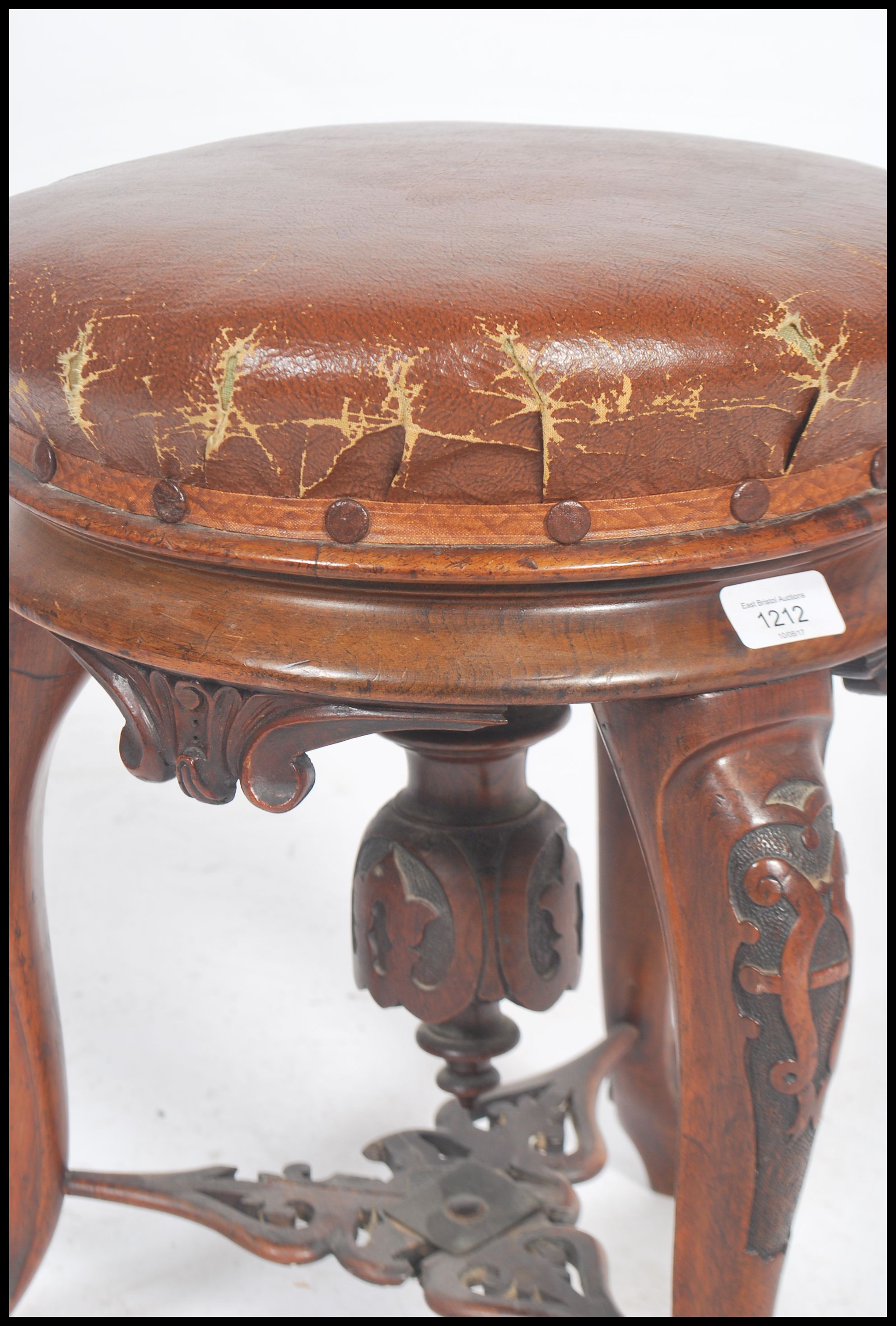 A Victorian tripod piano stool in walnut having lavishly carved cabriole legs and a faux leather - Image 3 of 5