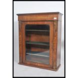 A Victorian walnut single door pier cabinet having