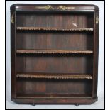 A large 19th century walnut library bookcase having adjustable leather arcade covered shelves with