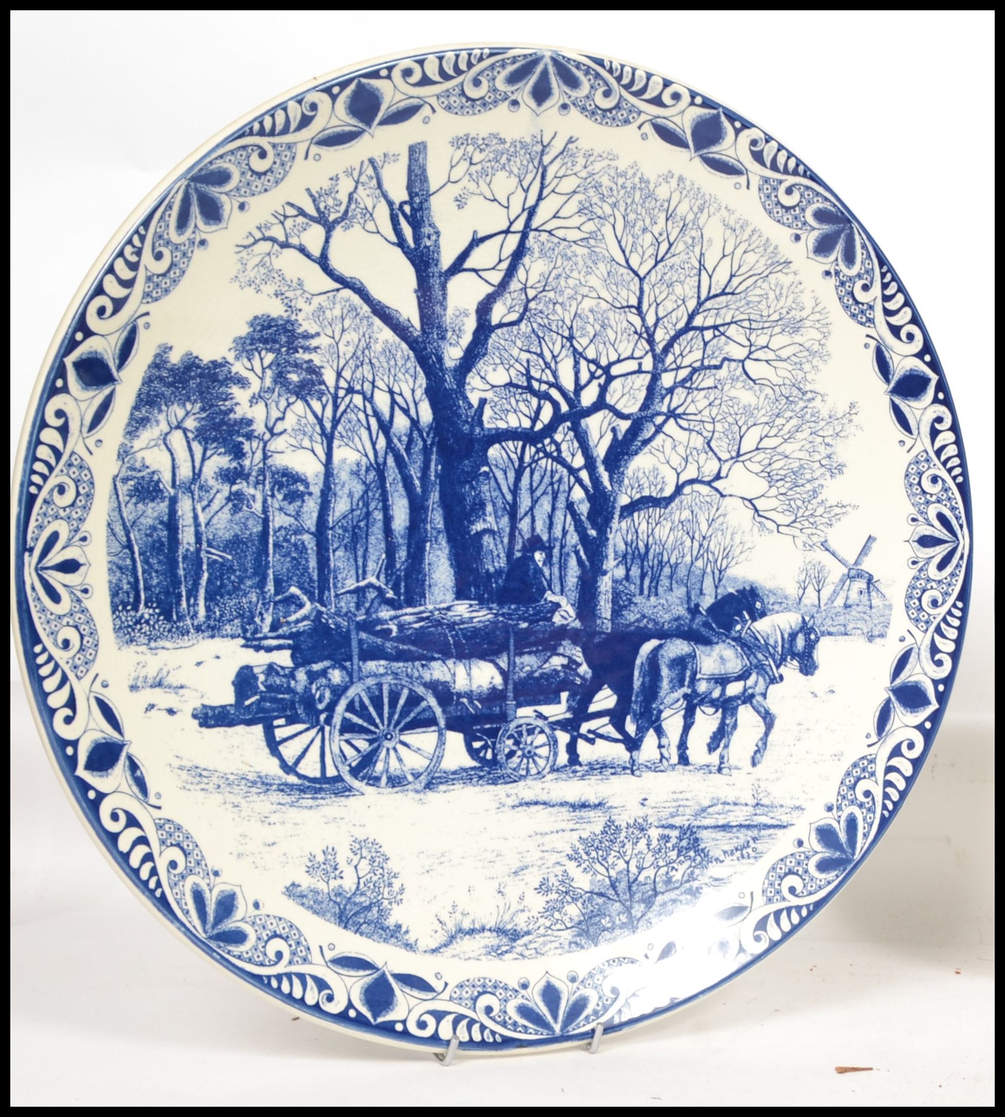 Two 20th century Delft ceramic wall hanging charger plates each having a central tondo depicting - Image 2 of 10