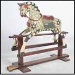 An early 20th Collinson child's rocking horse. Raised on a wooden glider, the dapple painted horse