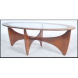 A 1970's G-Plan oblong teak model  ' Astro ' coffee table, with inset circular glass top over