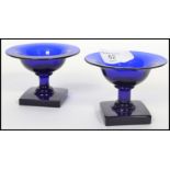 A rare pair of 18th century Bristol blue salt cellars raised on square plinth bases with waisted