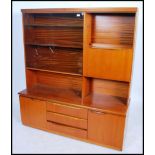 A 1970's teak wood bow fronted Danish influence high board sideboard cabinet having bow glass corner