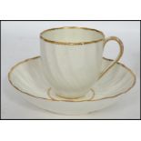 An 18th / 19th century Royal Crown Derby Regency cup and saucer having a plain white design with