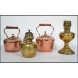 2 good Victorian copper kettles in the manner of Edward Wilkes together with a brass oil lamp and