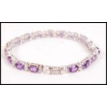 An impressive silver amethyst and cz adorned ladies tennis bracelet, each being bar linked and