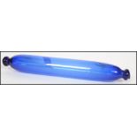 An 18th/19th century Bristol blue glass rolling pin having hole to one end for filling and remains