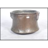 An 19th century / early 20th century copper pot / cauldron log coal bin with twin loop handles to