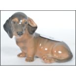 A Royal Copenhagen ceramic figurine of dachshund dog in a seated position 3140 with makers stamp
