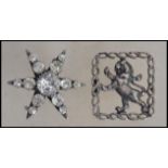 Two vintage early 20th century silver brooches, the first in the form of a star having paste stones,