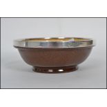 A studio art pottery bowl with a hallmarked silver rim for James Sherwood 1910 with notation '