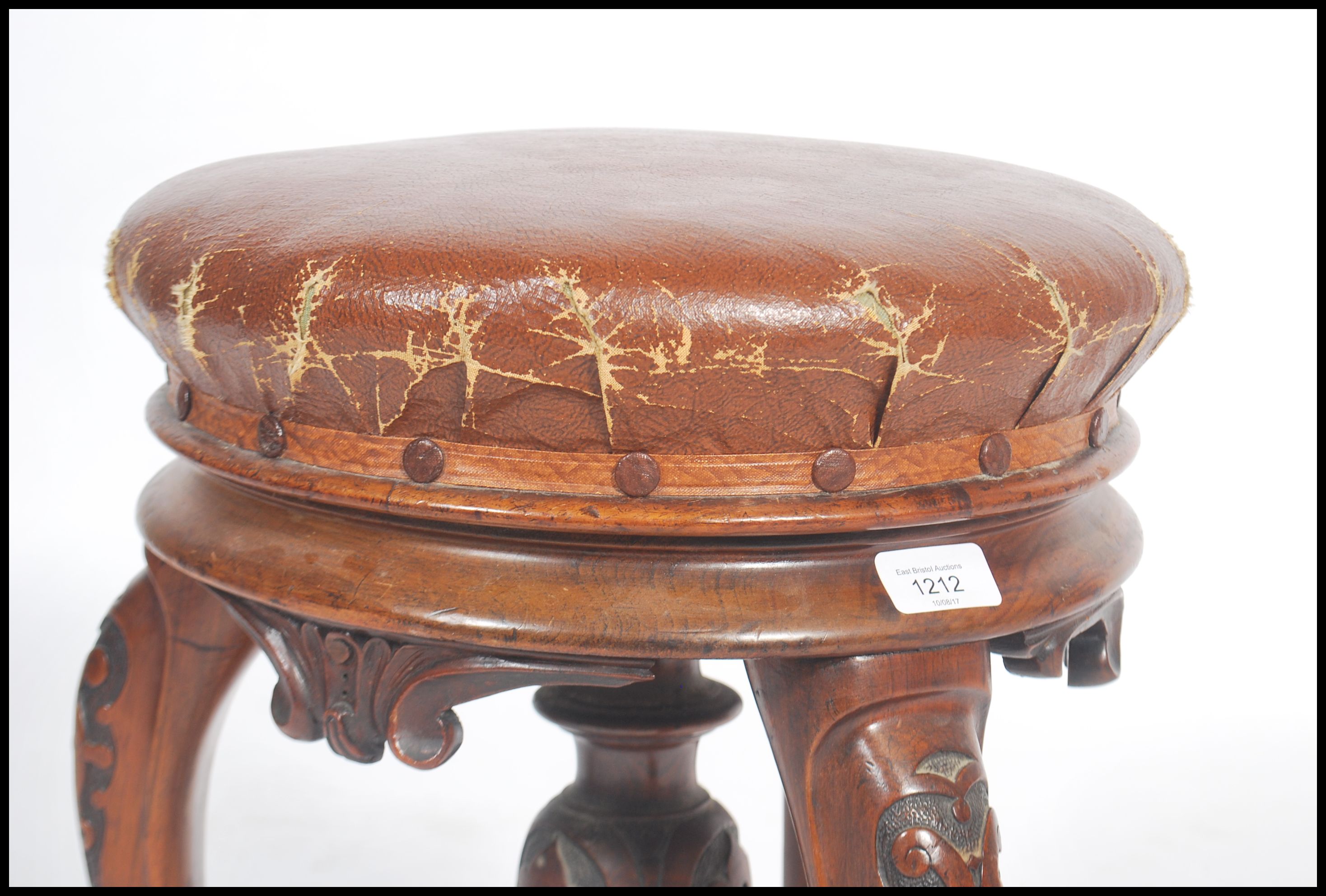 A Victorian tripod piano stool in walnut having lavishly carved cabriole legs and a faux leather - Image 5 of 5