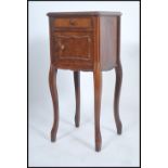 A 19th century French marble bedside cabinet having sabre legs with a cupboard under short drawer