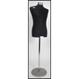 A retro style 20th century tailors haberdashery mannequin / shop dummy raised on a polished