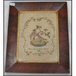 A 19th century Victorian period framed and glazed needlepoint tapestry sampler depicting nesting