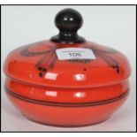 A 19th century glass lidded conserve pot in red having a black ball finial lid with a hand painted