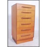 A 1970's G-Plan teak wood Kelso Pattern chest of drawers being raised on an inset plinth with