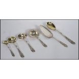 A collection of Danish Silver Plated serving spoons and ladels each with  with intricate rococo