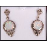 A pair of Art Deco style silver, marcasite and opal adorned ladies earrings complete in the