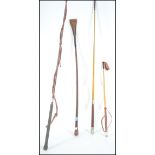 A group of vintage horse riding crops to include a silver hallmarked leather example bearing