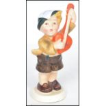 A rare believed unlisted 20th century Goebbels Hummel ceramic figurine of a boy playing a mandolin