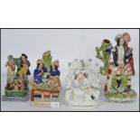 A good group of 19th century Victorian Staffordshire ceramic flat-back figurines to include a seated
