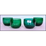 A set of four 18th century Georgian Bristol green glass finger bowls each having grounded out pontil