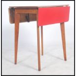 A vintage mid 20th century red topped Formica dining drop leaf table of smaller proportions raised