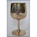 A hallmarked silver goblet raised on a plain base with tapering stem and bell shaped bowl to top.