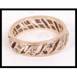 A 9ct gold and paste stone channel set vintage ladies eternity ring with pierced centres being