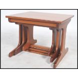 A set retro 20th century teak wood Danish influenced nest of three inter-sliding occasional