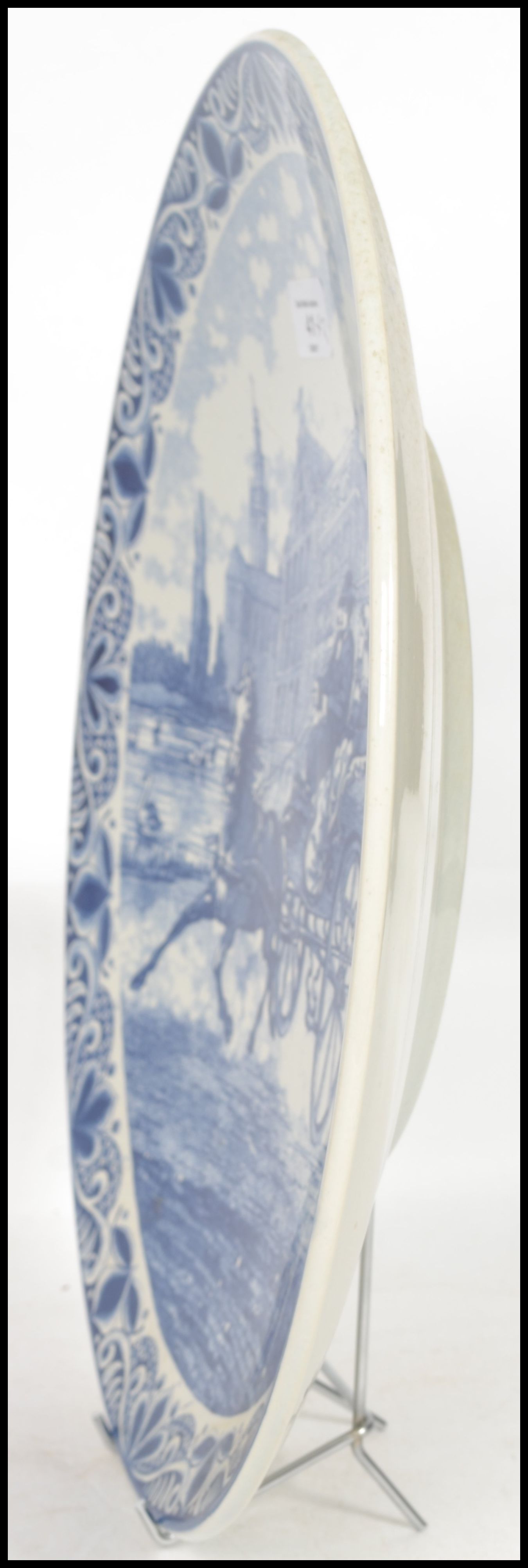 Two 20th century Delft ceramic wall hanging charger plates each having a central tondo depicting - Image 7 of 10