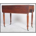 A Victorian mahogany pembroke table being raised on turned legs with drawer to end. The drop