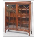 An Edwardian mahogany library bookcase cabinet raised on squared legs having twin astragal glazed