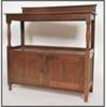 A Victorian oak buffet side table having twin door