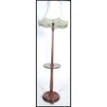 A 19th century Victorian mahogany standard lamp having a circular base with block and turned stem