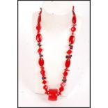 A vintage red glass, garnet and coral necklace with faceted and cube glass beads with s clasp.