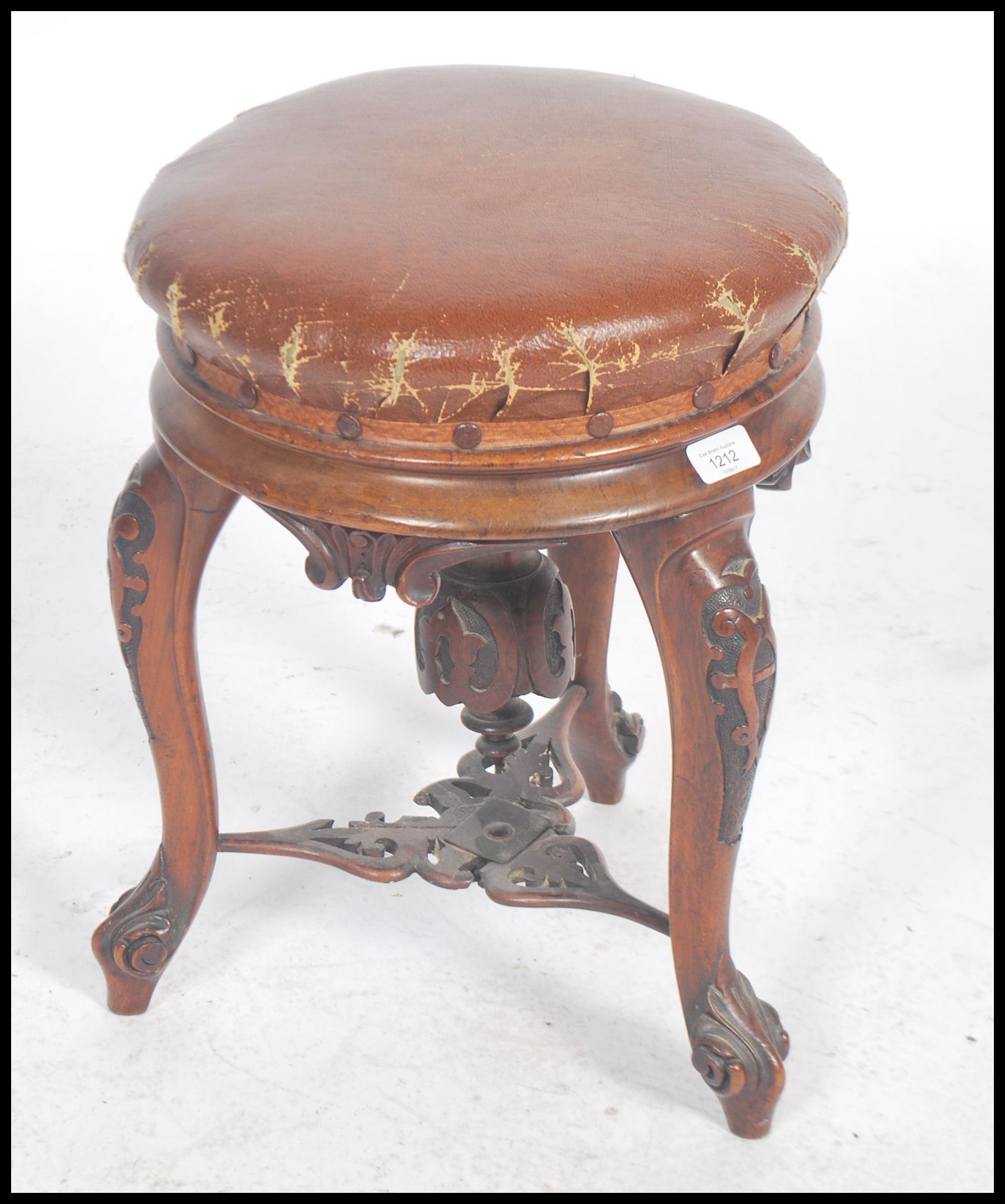 A Victorian tripod piano stool in walnut having lavishly carved cabriole legs and a faux leather - Image 2 of 5